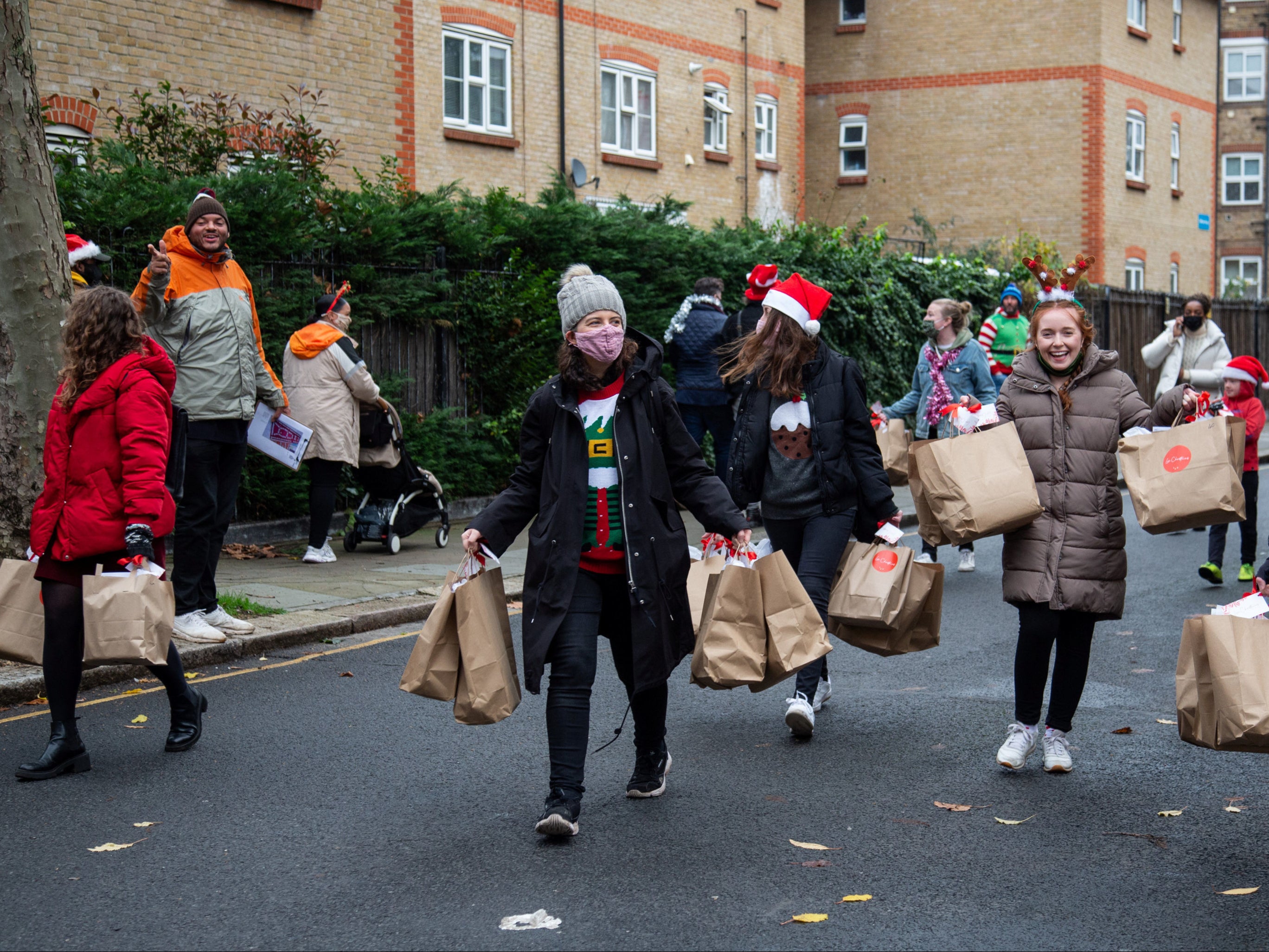 Volunteers from St Francis Church on the Dalgarno Estate in West London delivering some of the 1500 Christmas boxes to residents as part of the the national ‘Love Christmas’ initiative