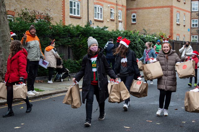 <p>Volunteers from St Francis Church on the Dalgarno Estate in West London delivering some of the 1500 Christmas boxes to residents as part of the the national ‘Love Christmas’ initiative</p>