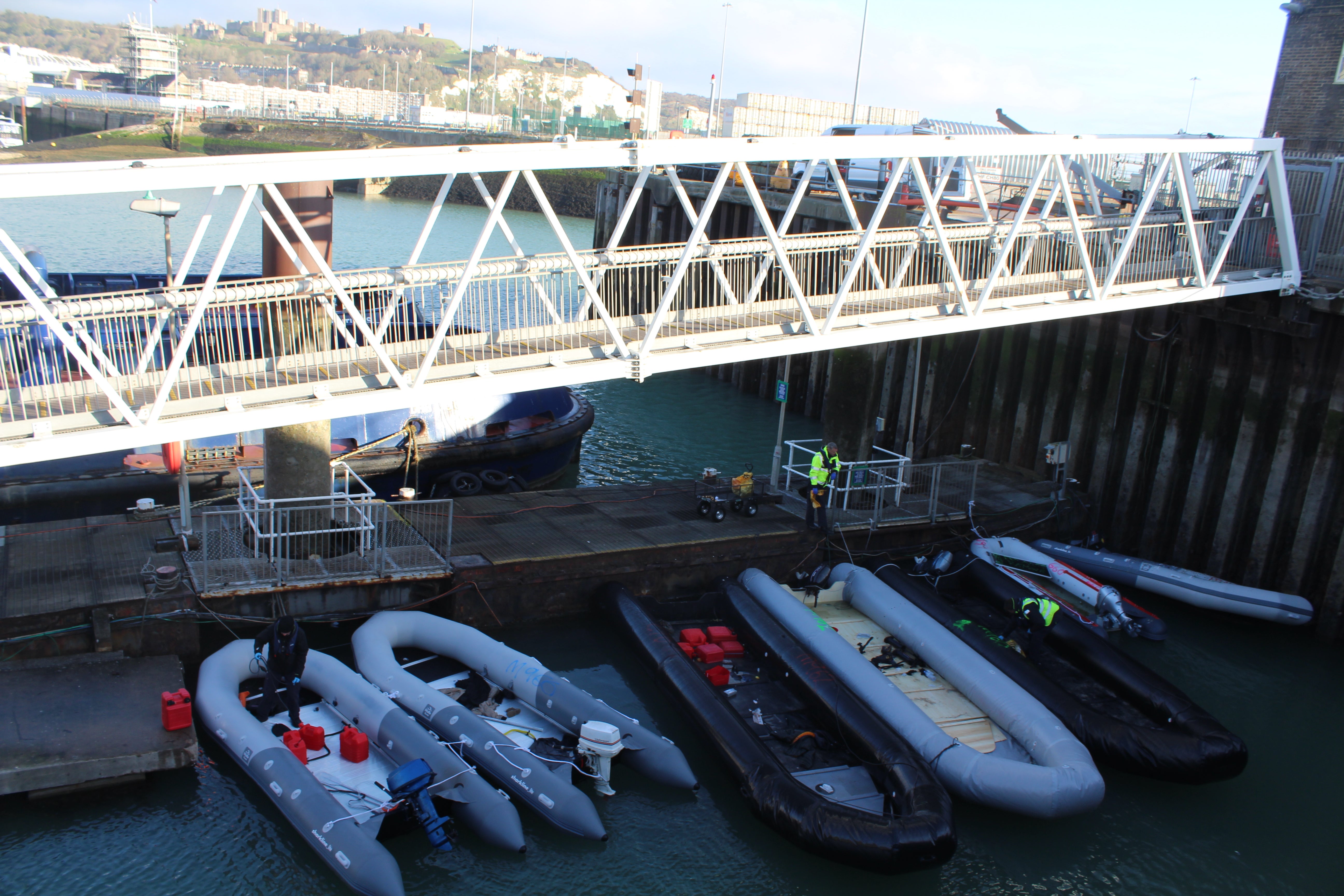 Migrant boats are stored in the marina