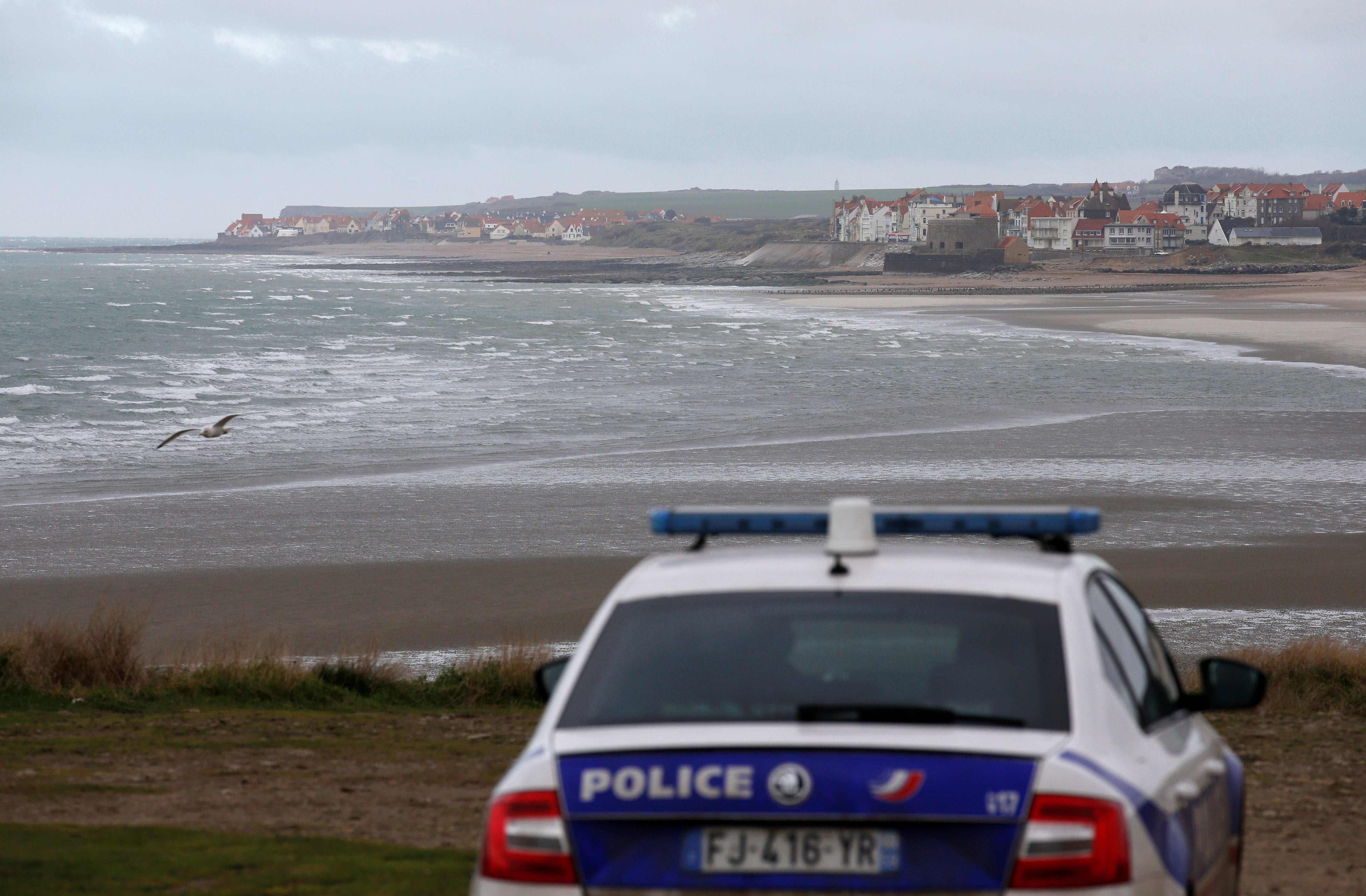 French police patrol near the Slack dunes, the day after 27 migrants died when their dinghy deflated as they attempted to cross the English Channel, in Wimereux, near Calais