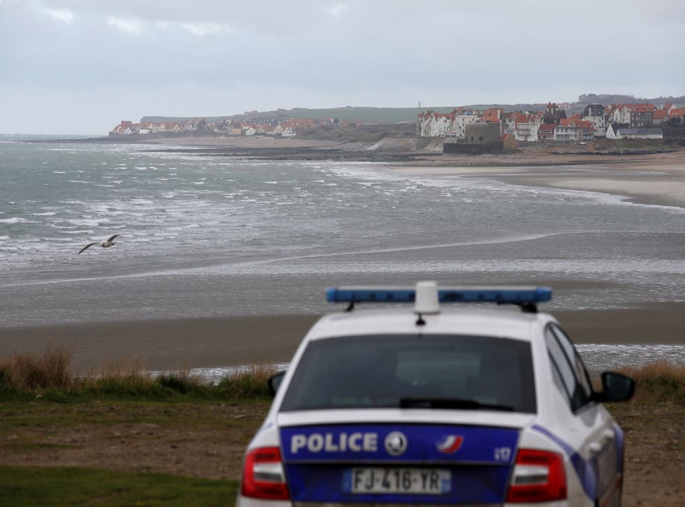 <p>French police patrol near the Slack dunes, the day after 27 migrants died when their dinghy deflated as they attempted to cross the English Channel, in Wimereux, near Calais</p>
