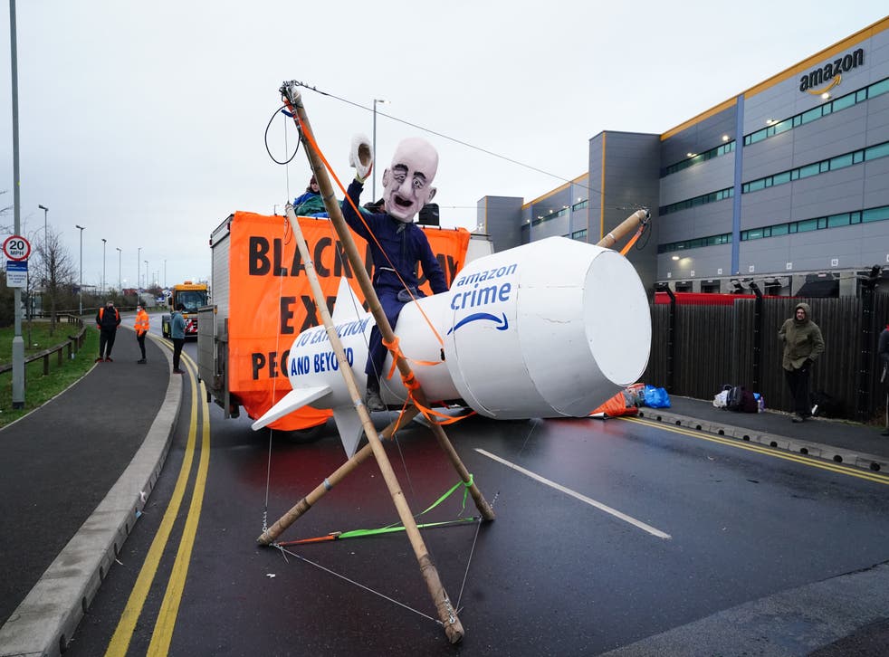 Black Friday protests: Jeff Bezos caricature rides rocket as Extinction  Rebellion block 15 Amazon depots | indy100