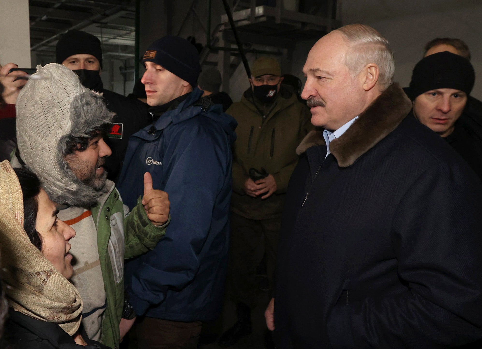 Belarusian president Alexander Lukashenko meets migrants as he visits the transport and logistics centre in Bruzgi on the Belarusian-Polish border