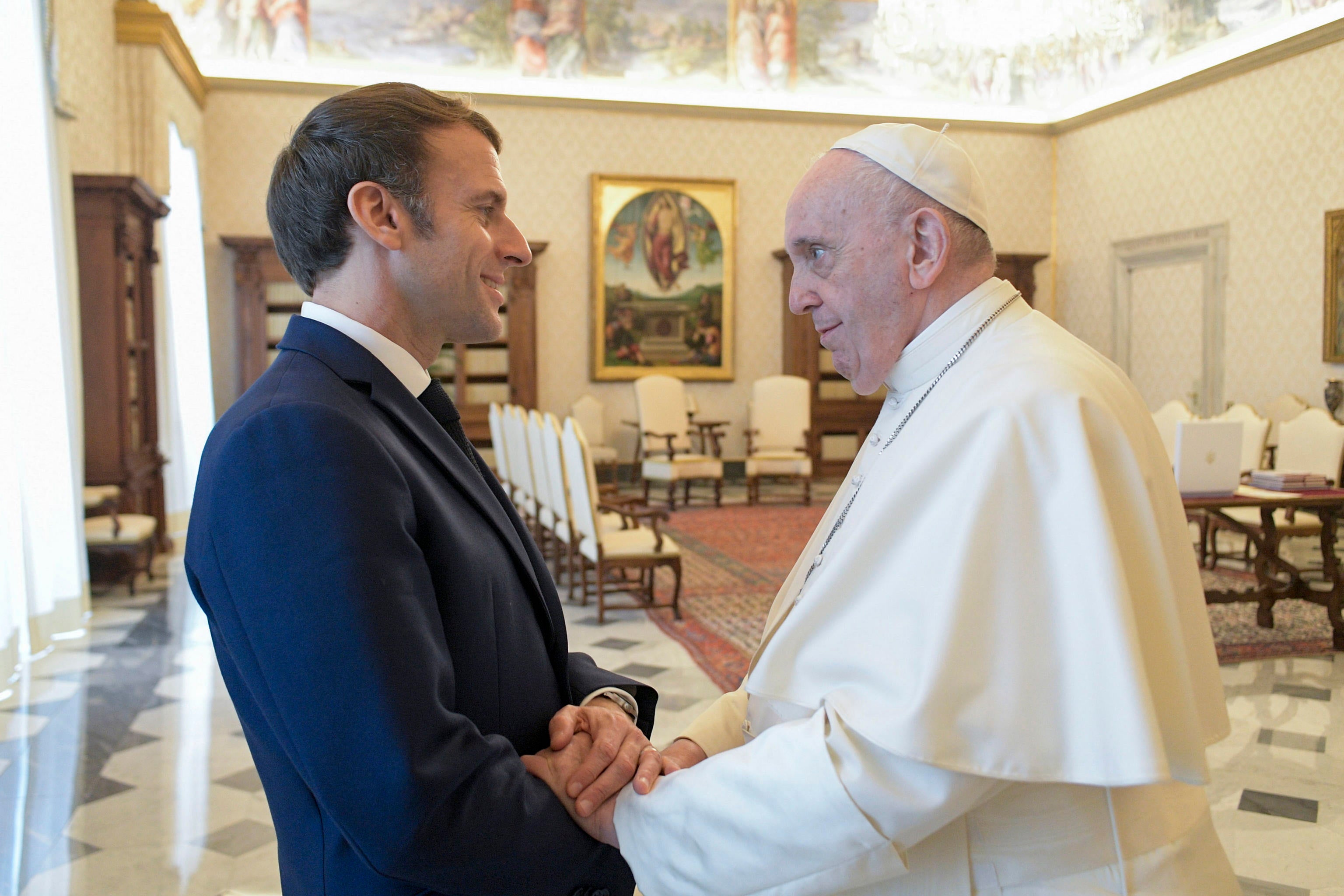 Pope Francis (R) receives French President Emmanuel Macron (L) in a private audience at the Vatican