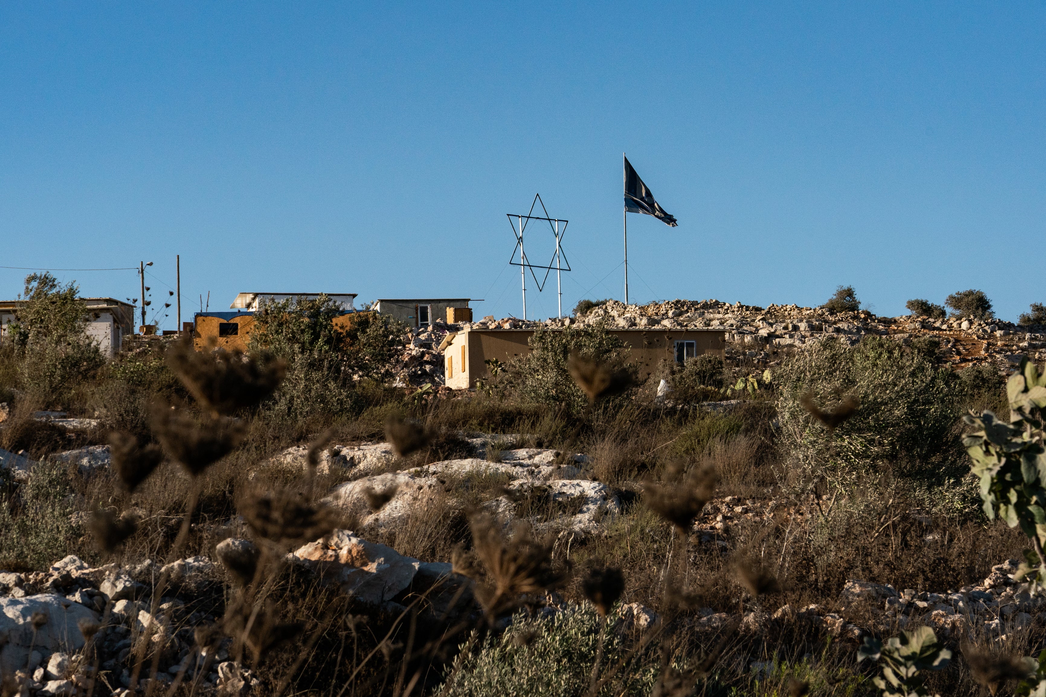 A large Star of David looms over the homes quickly erected in the Israeli settlement of Evyatar