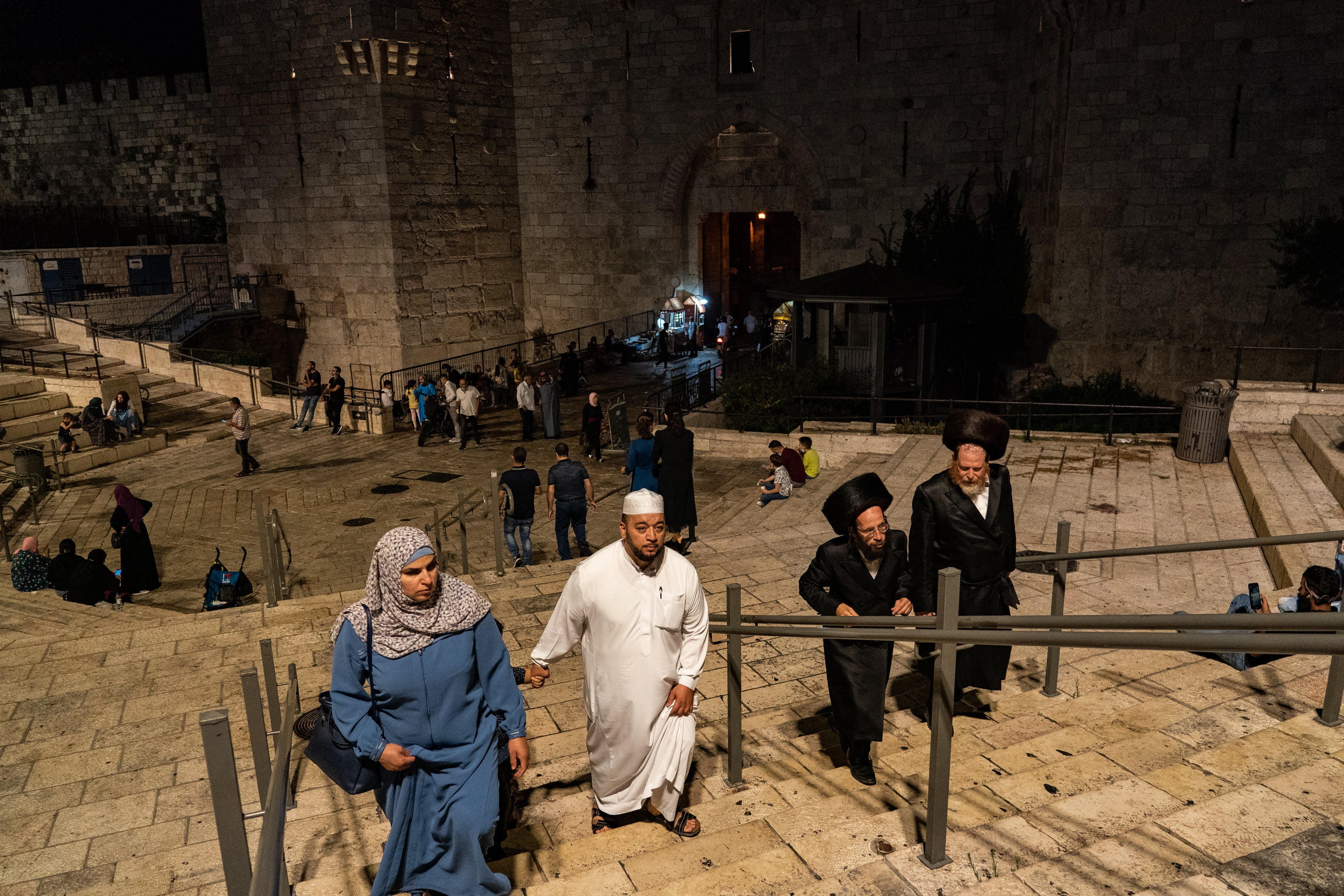 Muslims and Jews make their way out of Jerusalem’s Old City through Damascus Gate