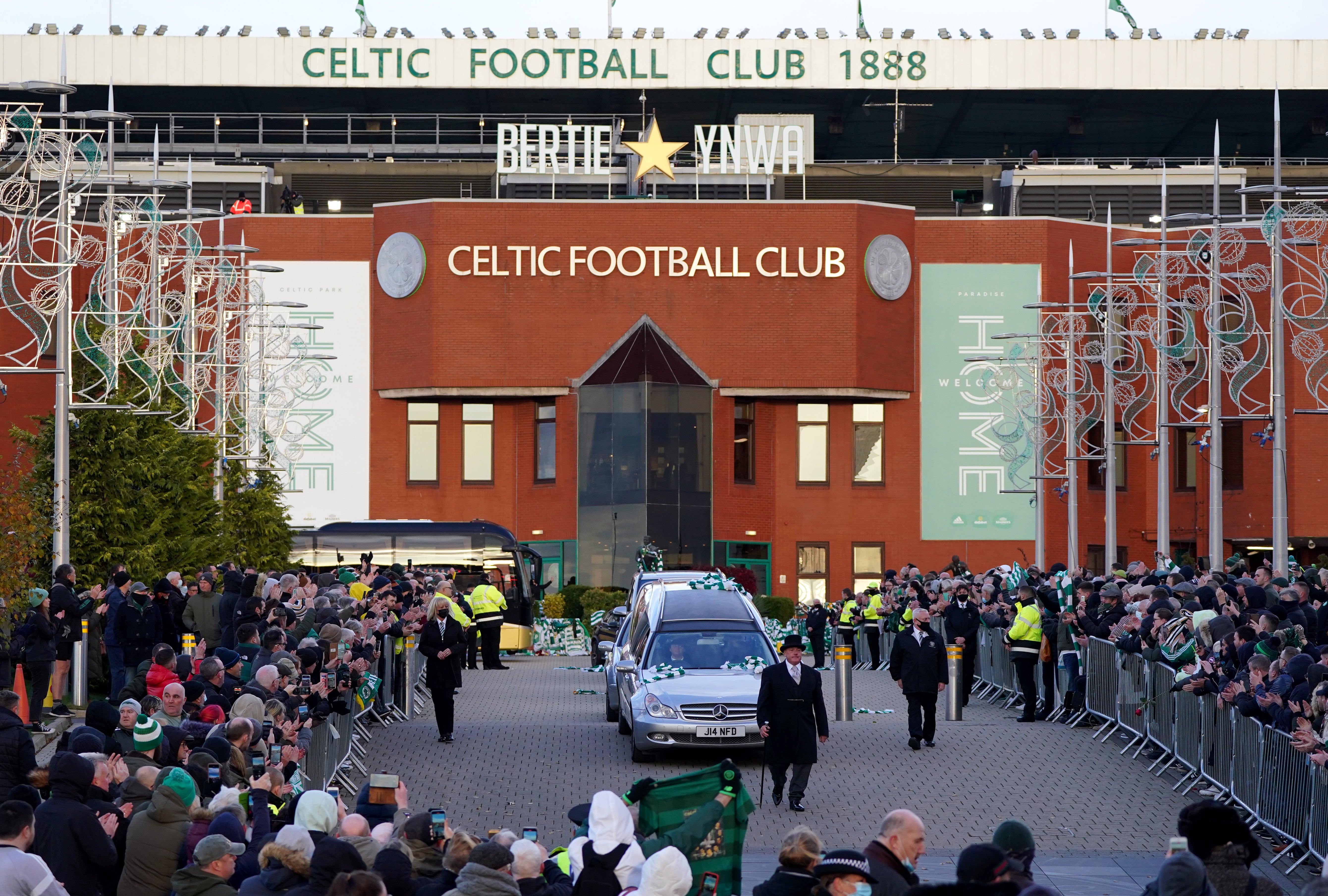 The funeral cortege for Bertie Auld passes Celtic Park (Andrew Milligan/PA)