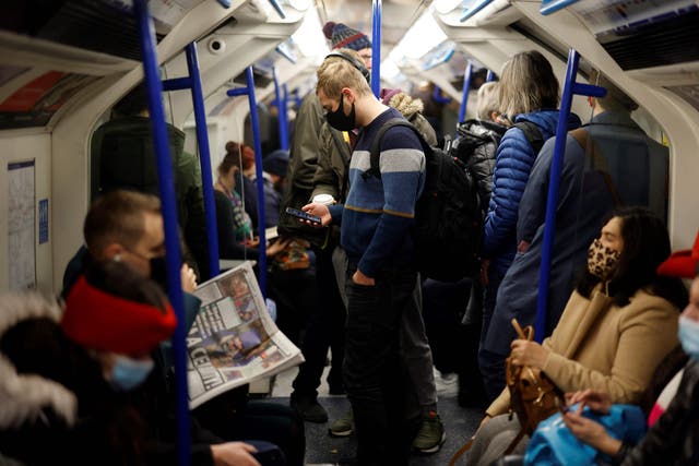 <p>Commuters travel towards central London on a busy Victoria Line tube train</p>