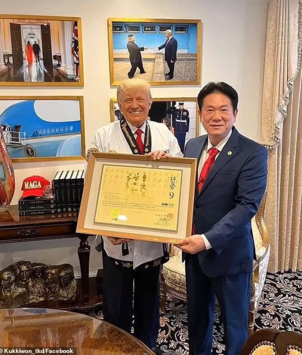 Mr Trump’s Mount Rushmore statue can be clearly seen in this photo with the president of Kukkiwon Taekwando Lee Dong-sup