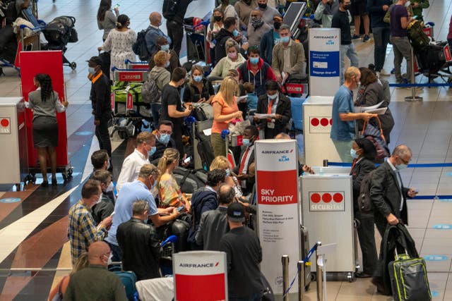 <p>People queue for a flight to Paris from Johannesburg</p>