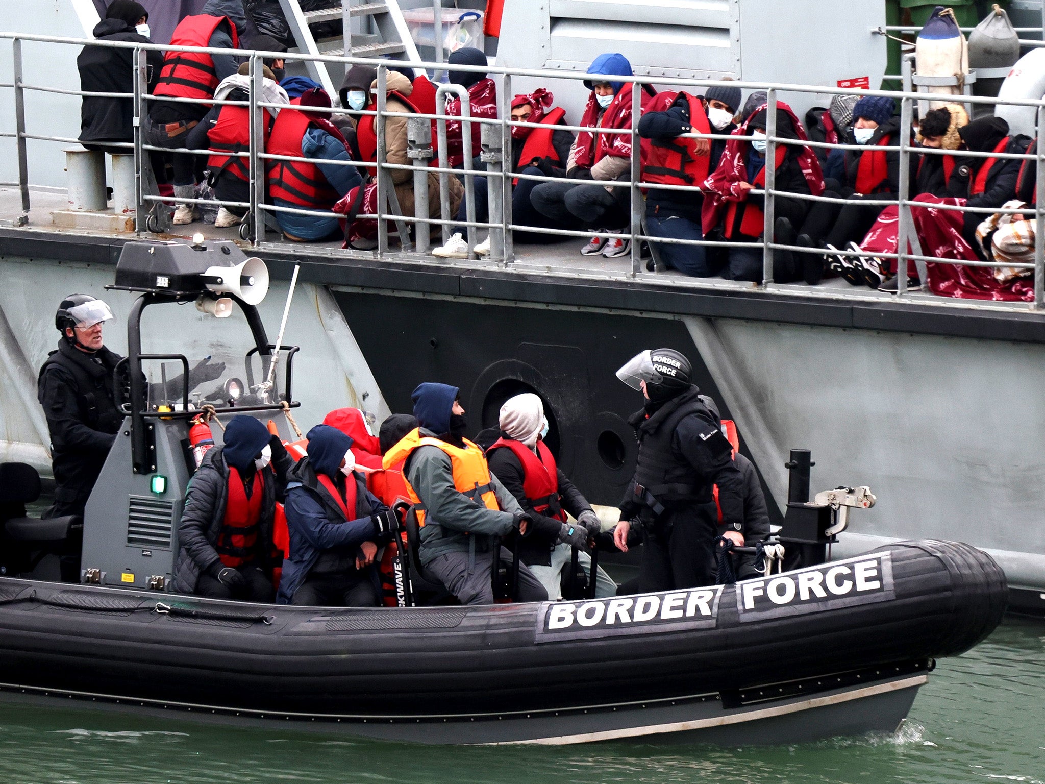 Migrants are taken ashore by UK Border Force at Dover last month