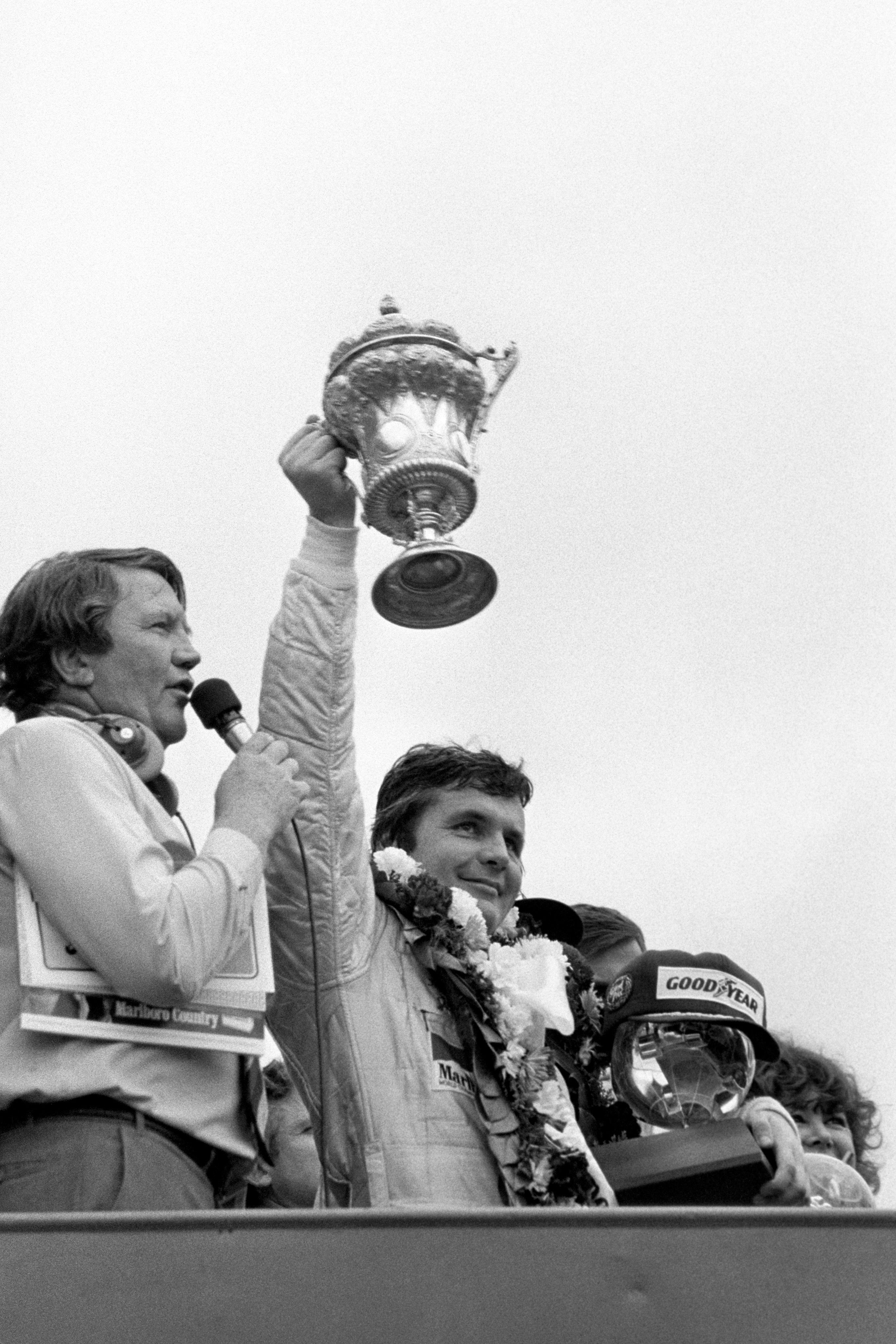 Australia’s Alan Jones lifts the winners trophy after victory in the British Grand Prix at Brands Hatch aboard his Saudia Leyland Williams (PA)