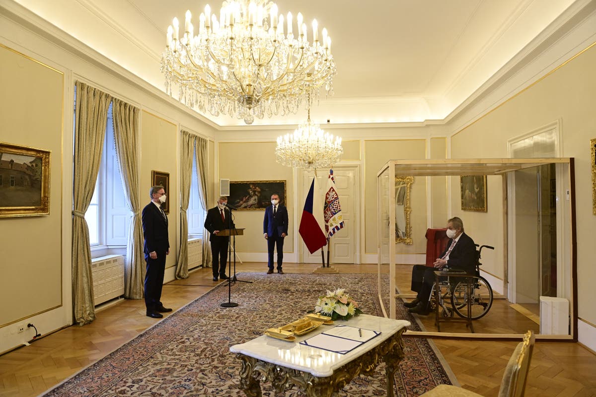 Czech president appoints new prime minister in ceremony behind glass