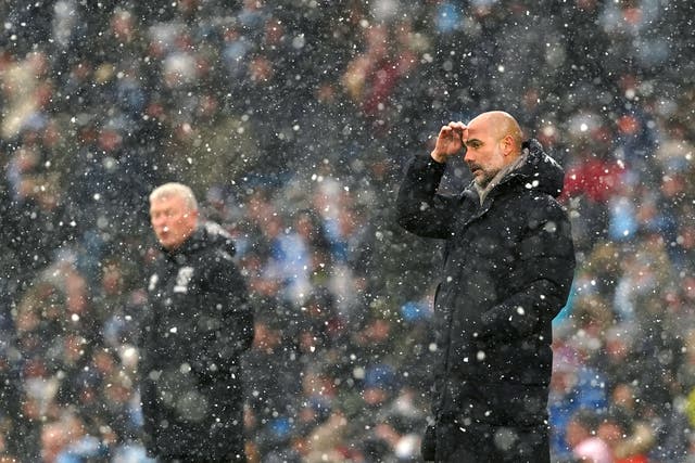 Pep Guardiola (right) got the better of David Moyes in snowy Manchester (Martin Rickett/PA)
