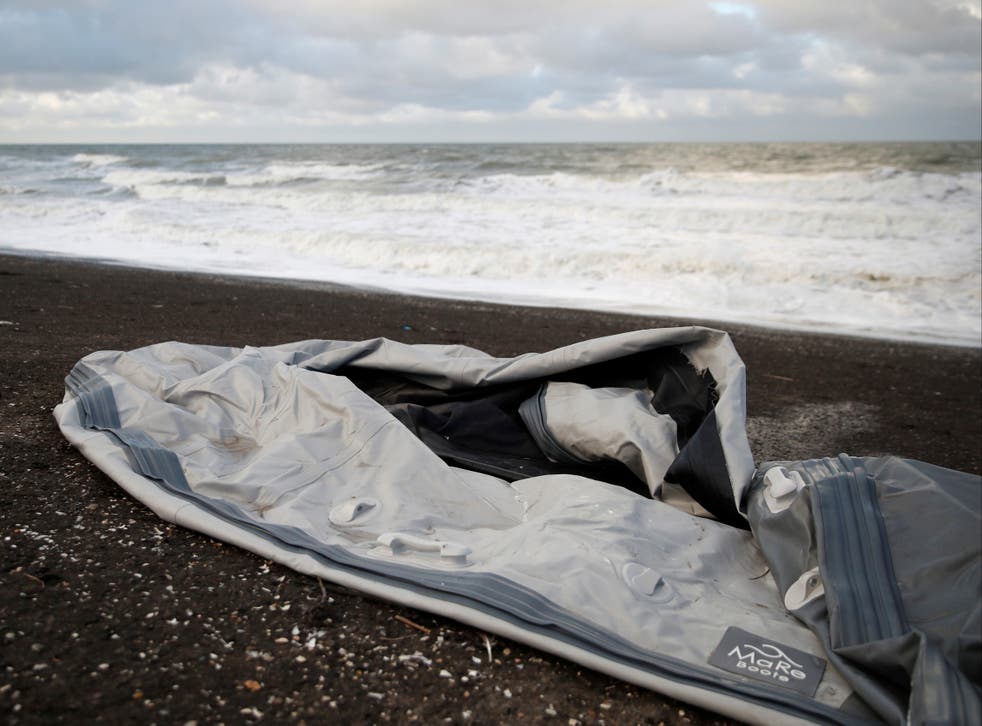 <p>A damaged inflatable dinghy is seen on Loon Beach, the day after 27 migrants died when their dinghy deflated as they attempted to cross the English Channel</p>