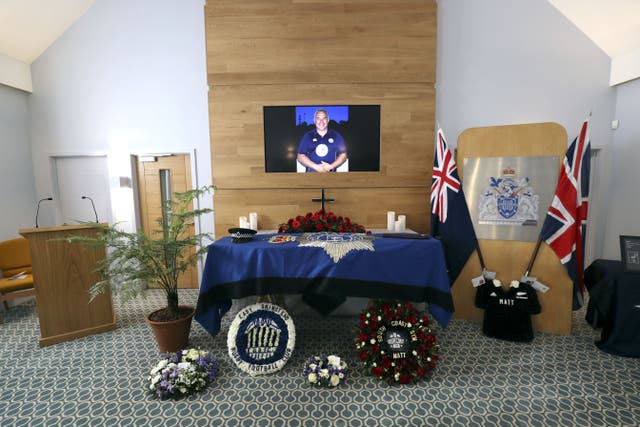 The coffin and floral tributes in the church before the funeral service of police officer Sergeant Matt Ratana (Gareth Fuller/PA)