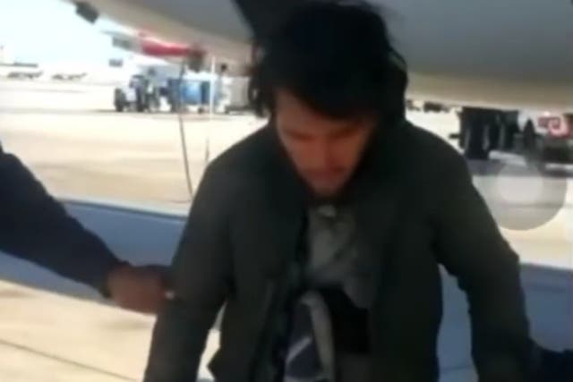 <p>The unidentified man on the tarmac of the Miami International Airport, after arriving in the landing gear of the American Airlines flight on 27 November 2021</p>