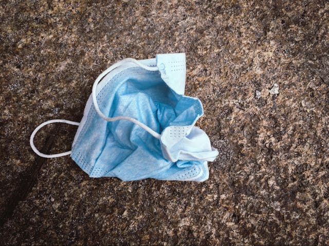 <p>A face mask thrown on the ground </p>