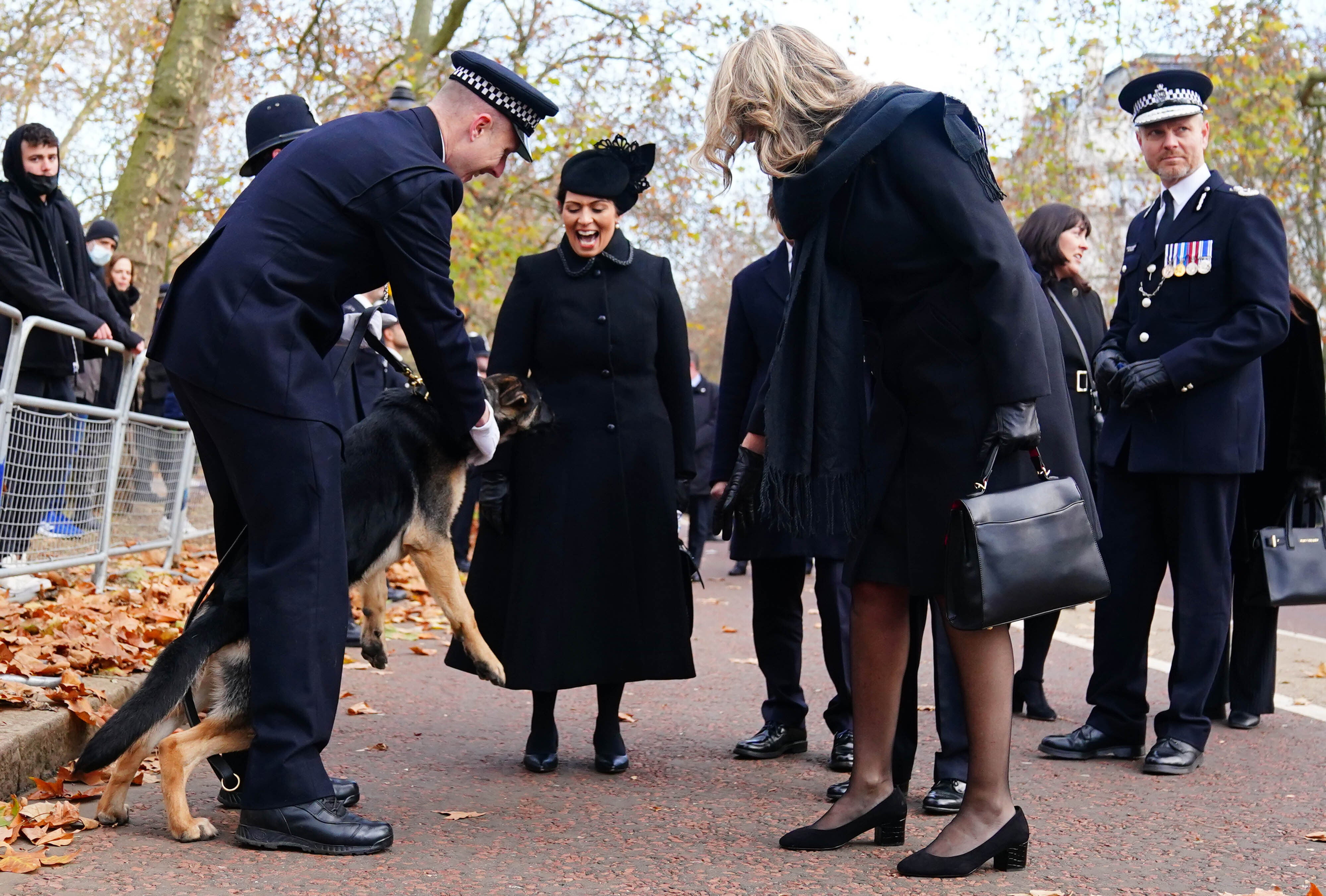 Sgt Ratana’s partner Su Bushby (centre right) meets a police dog that she named outside the chapel (Victoria Jones/PA)