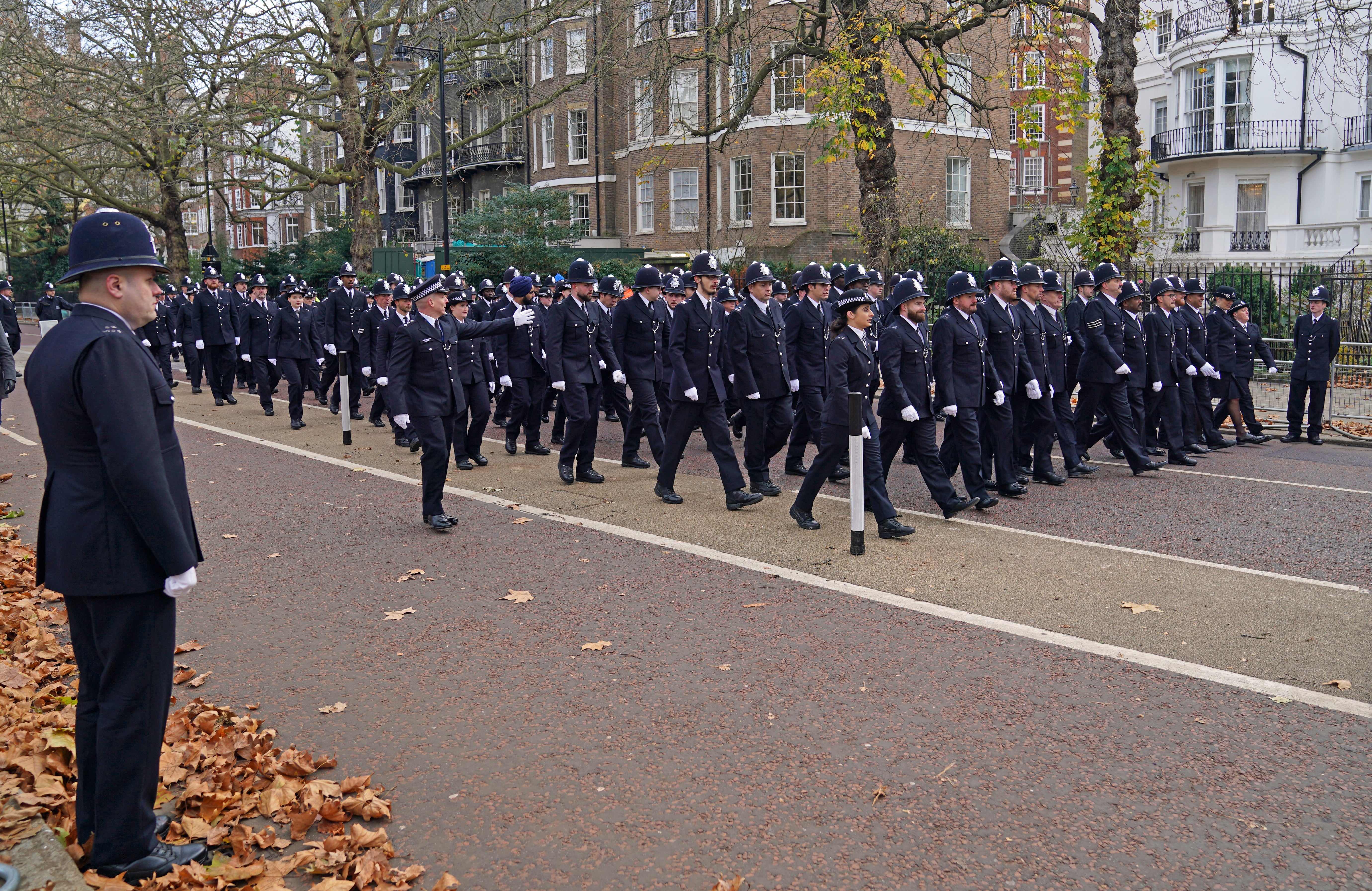 Police officers march to the memorial service (Steve Parsons/PA)