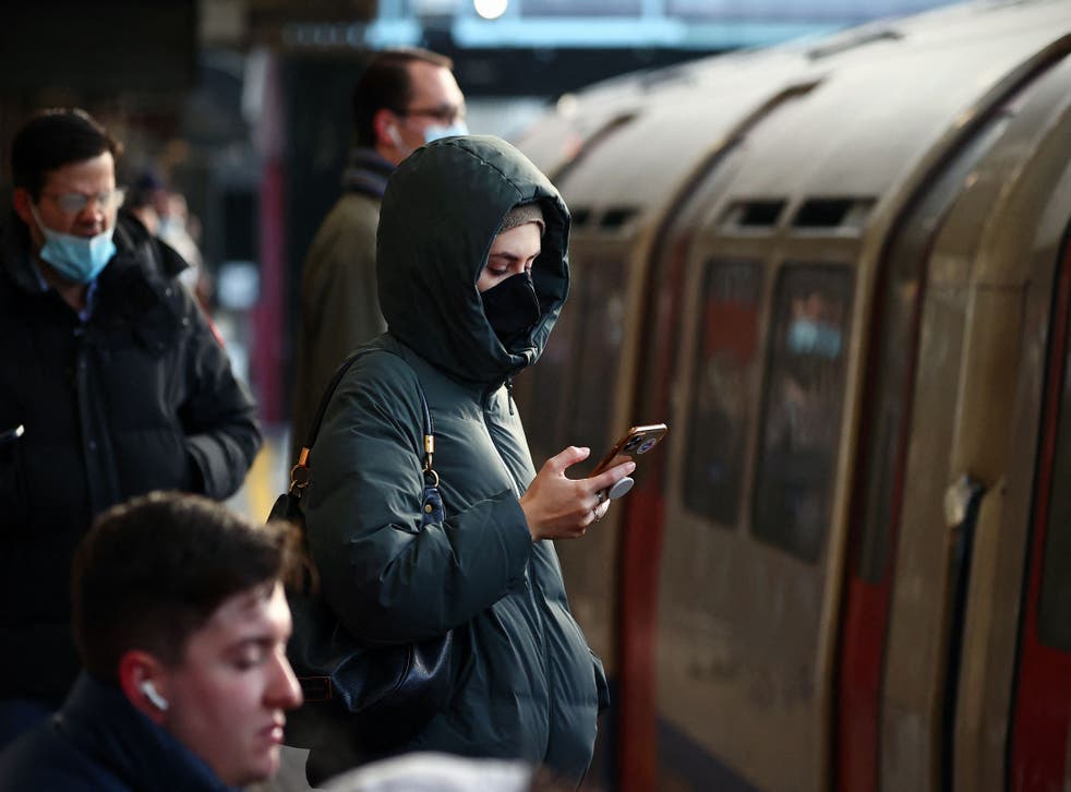<p>Commuters wait on a platform at Barons Court Underground station a day before masks will be made compulsory again </p>