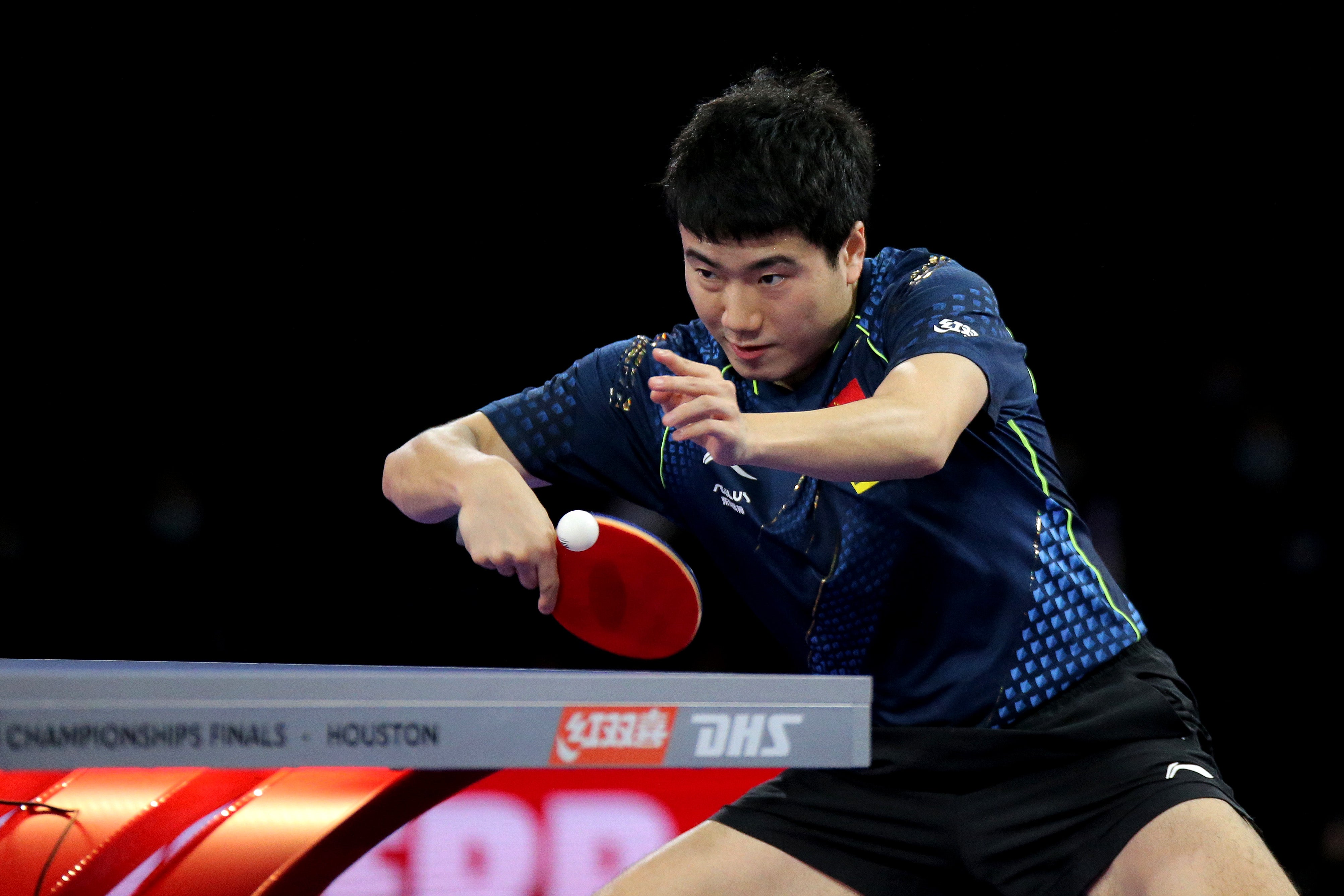 Liang Jingkun of China competes against Fan Zhendong of China