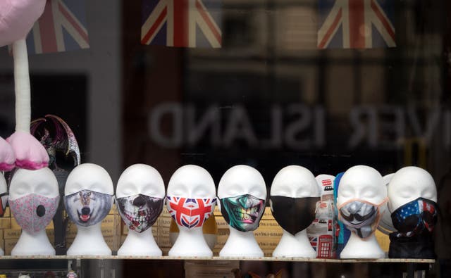 Face masks on display in a shop window (Andrew Matthews/PA)