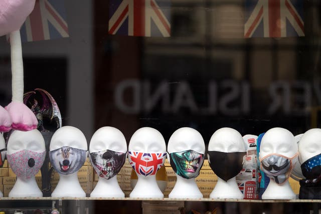 Face masks on display in a shop window (Andrew Matthews/PA)