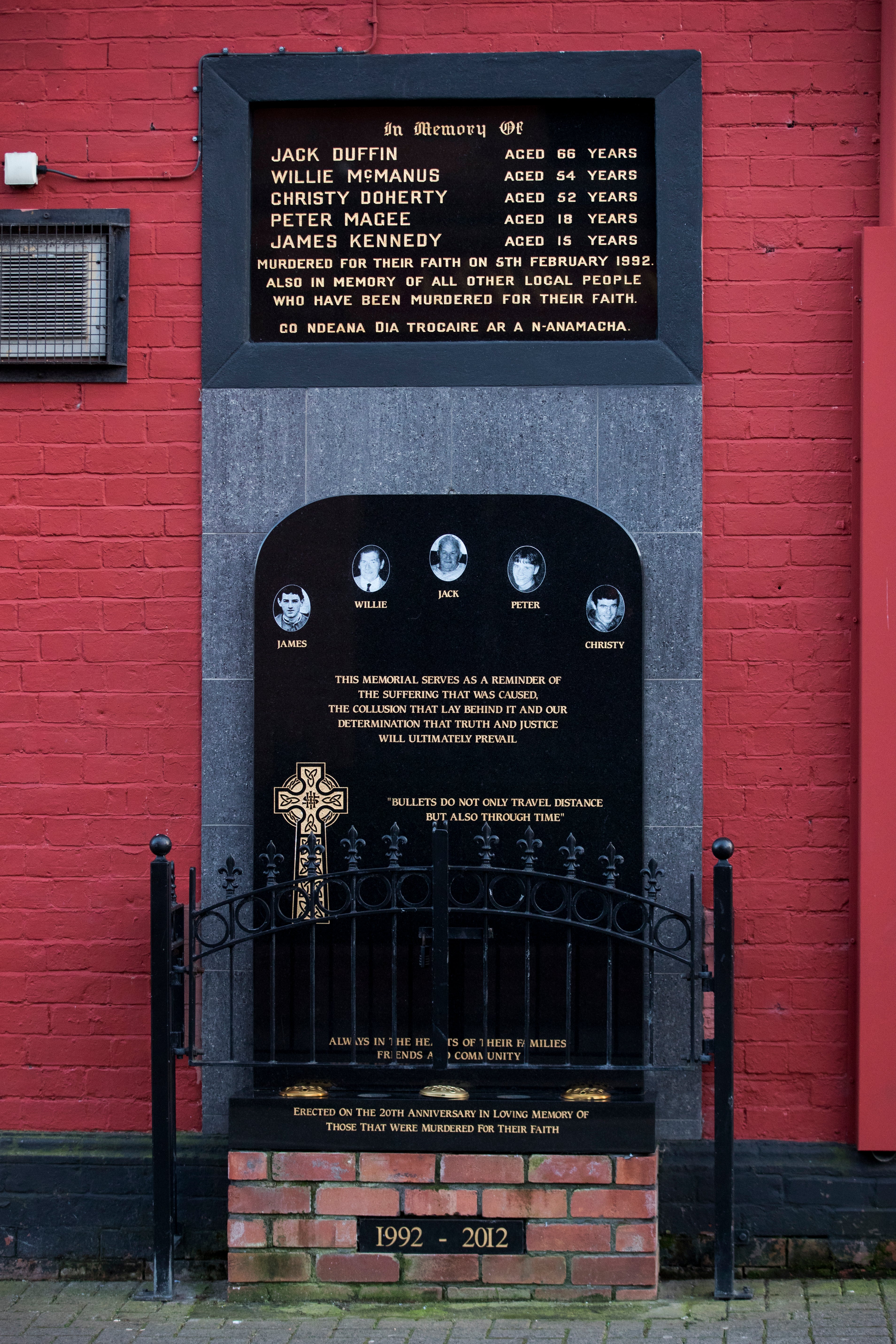 A memorial to men killed during the Sean Graham bookmakers attack in February 1992 (PA)