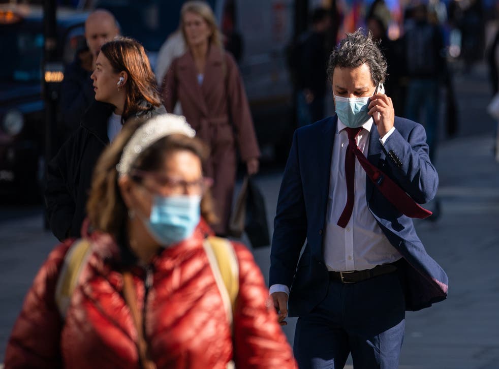 People wearing face masks on Oxford Street, in central London, as the Department of Health and Social Care is calling upon eligible people to get their covid-19 booster vaccinations (PA)
