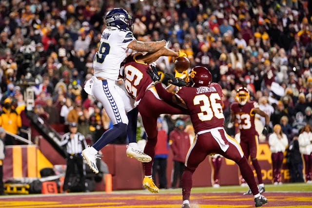 Washington cornerback Kendall Fuller (29) intercepts a pass in the end zone intended for Seattle Seahawks wide receiver Freddie Swain (Julio Cortez/AP)