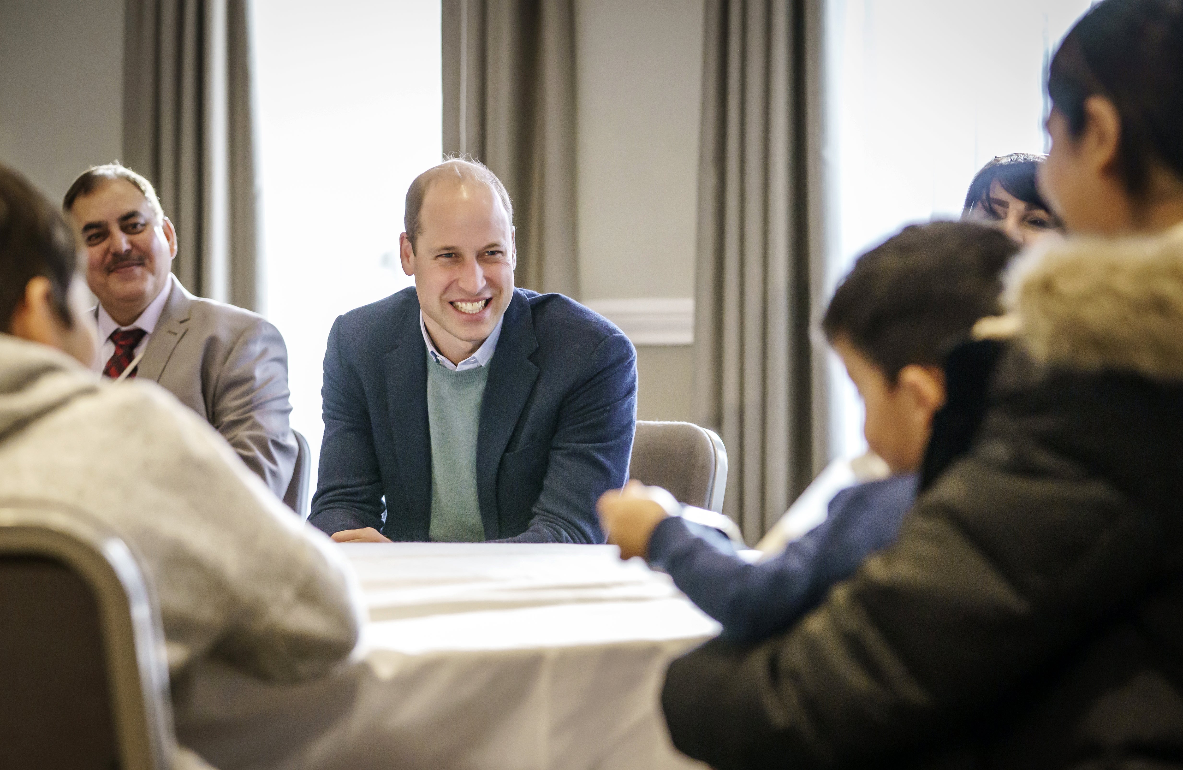 The Duke of Cambridge speaks to refugees during a visit to a local hotel in Leeds, which is being used to accommodate refugees evacuated from Afghanistan (PA)