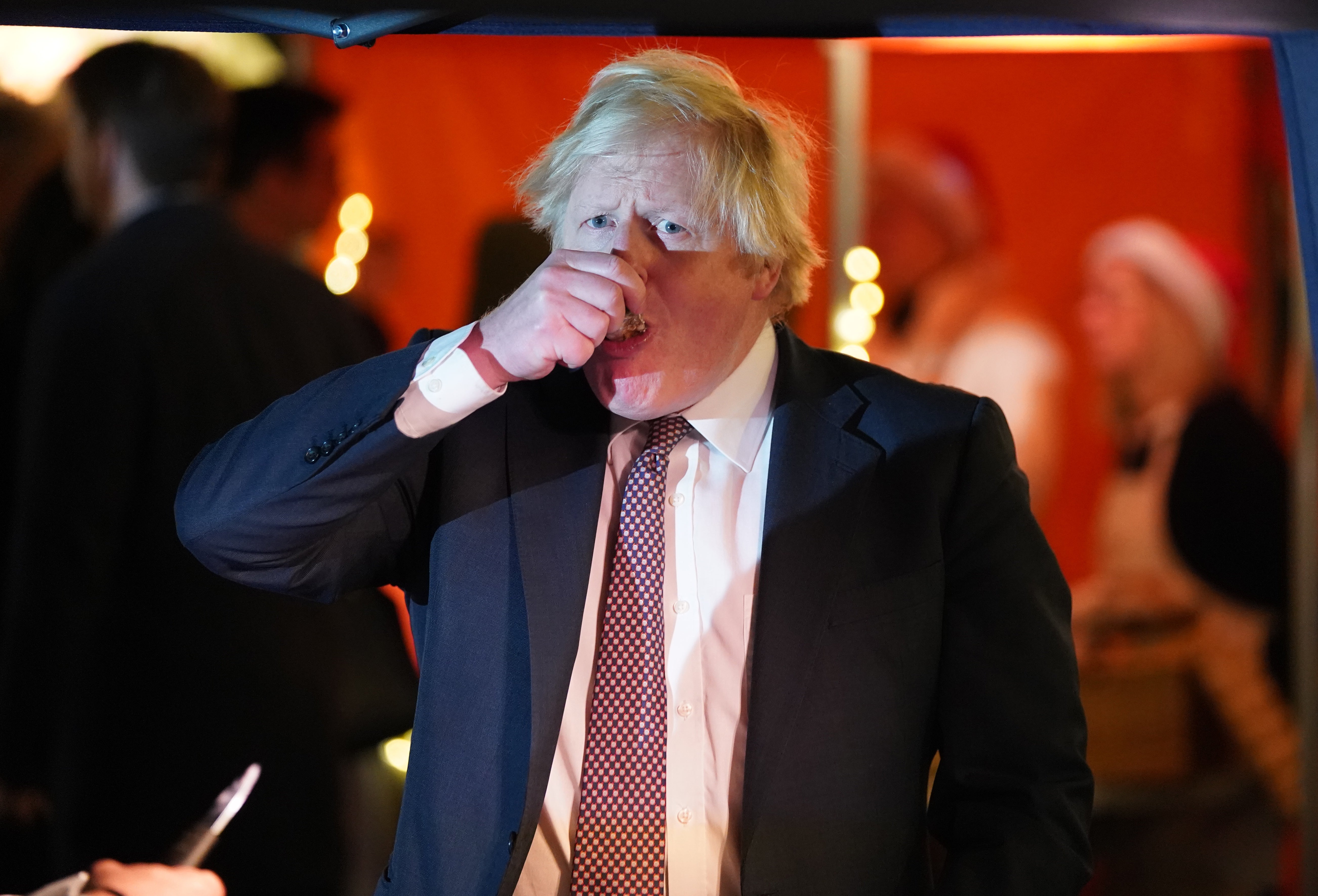 Boris Johnson samples the goods as he visited a UK Food and Drinks market set up in Downing Street on Tuesday (Stefan Rousseau/PA)