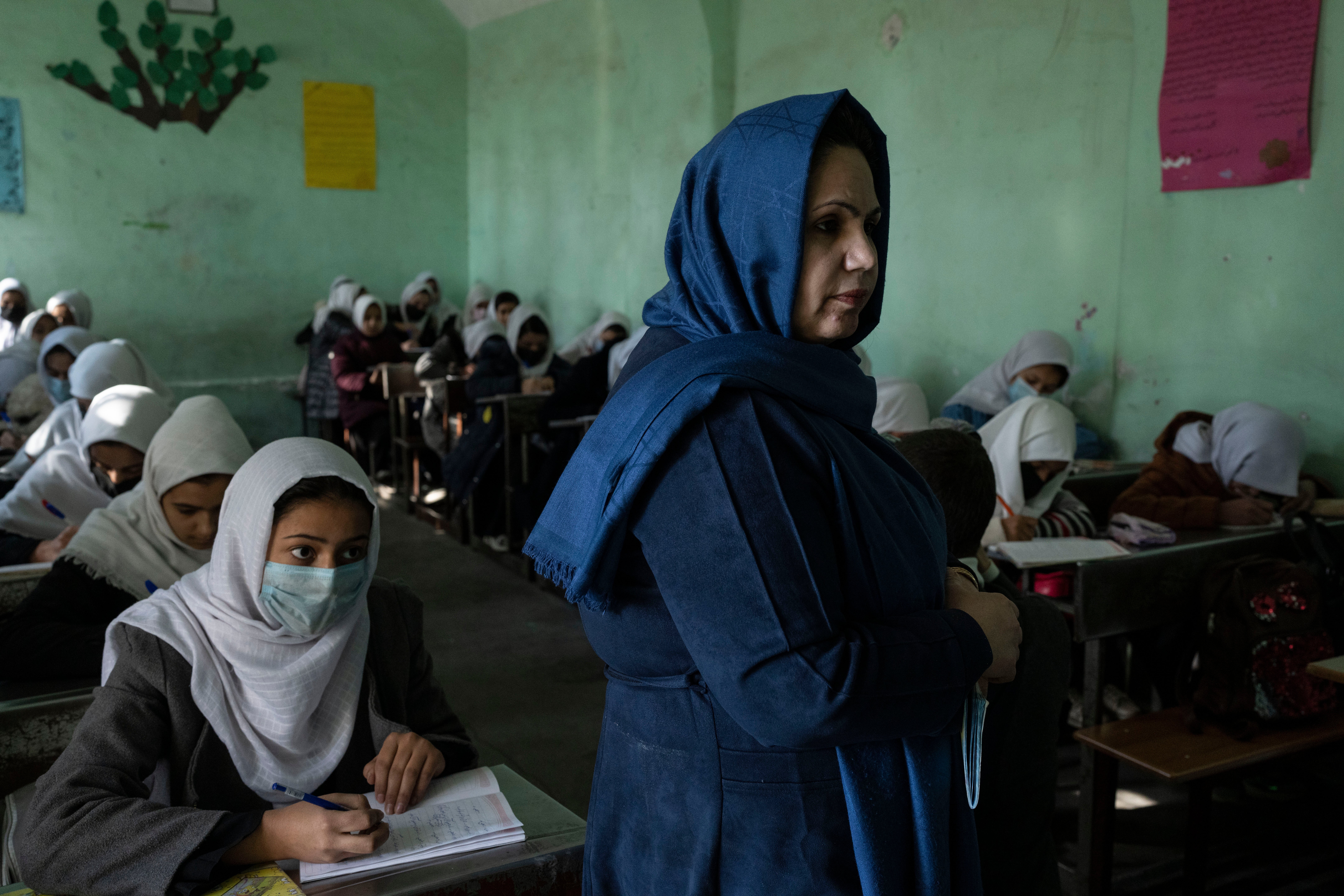 Afghan girls listen to their teacher at a school in Herat