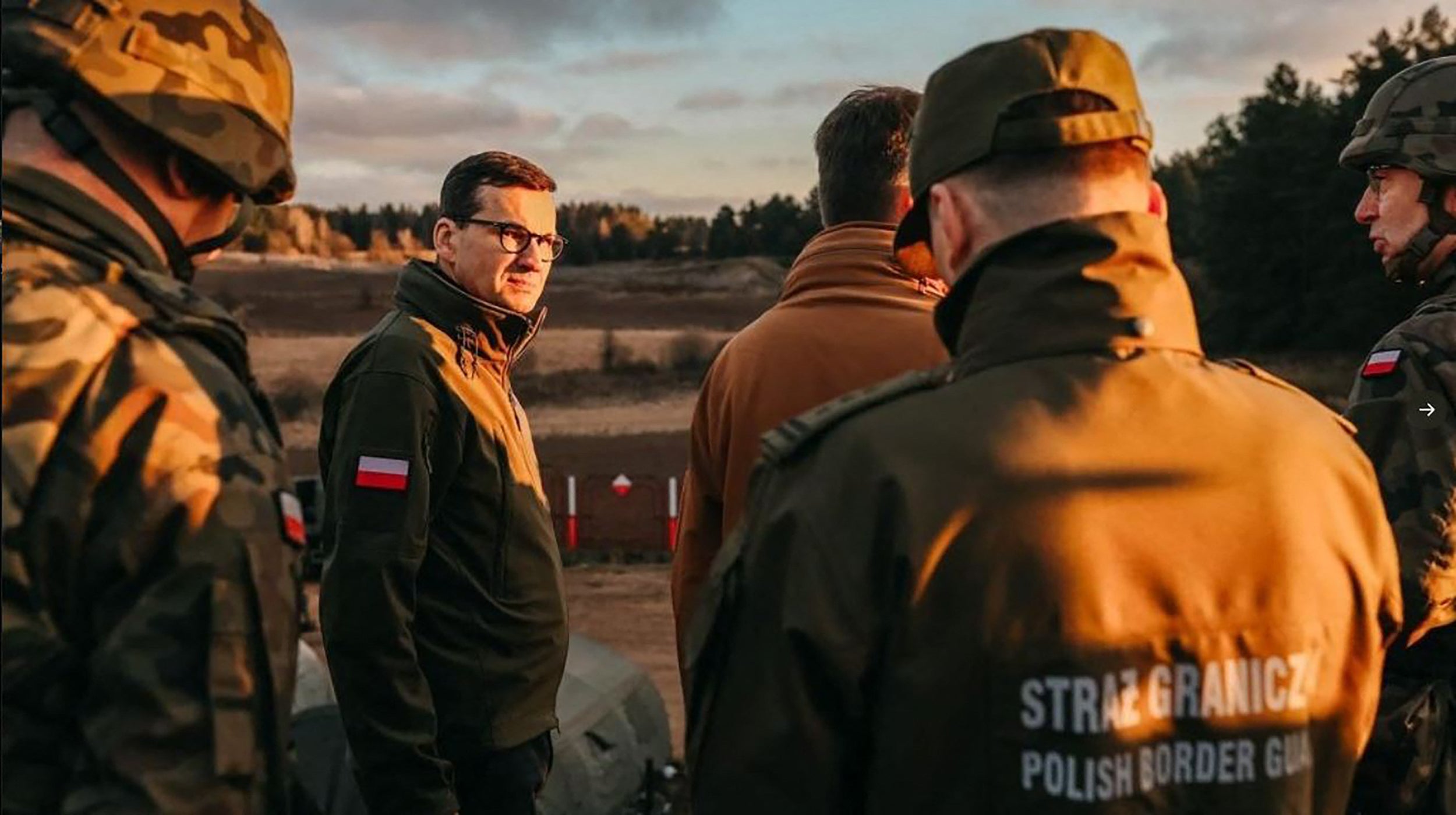 Poland’s Prime Minister Mateusz Morawiecki with border guards at the border with Belarus