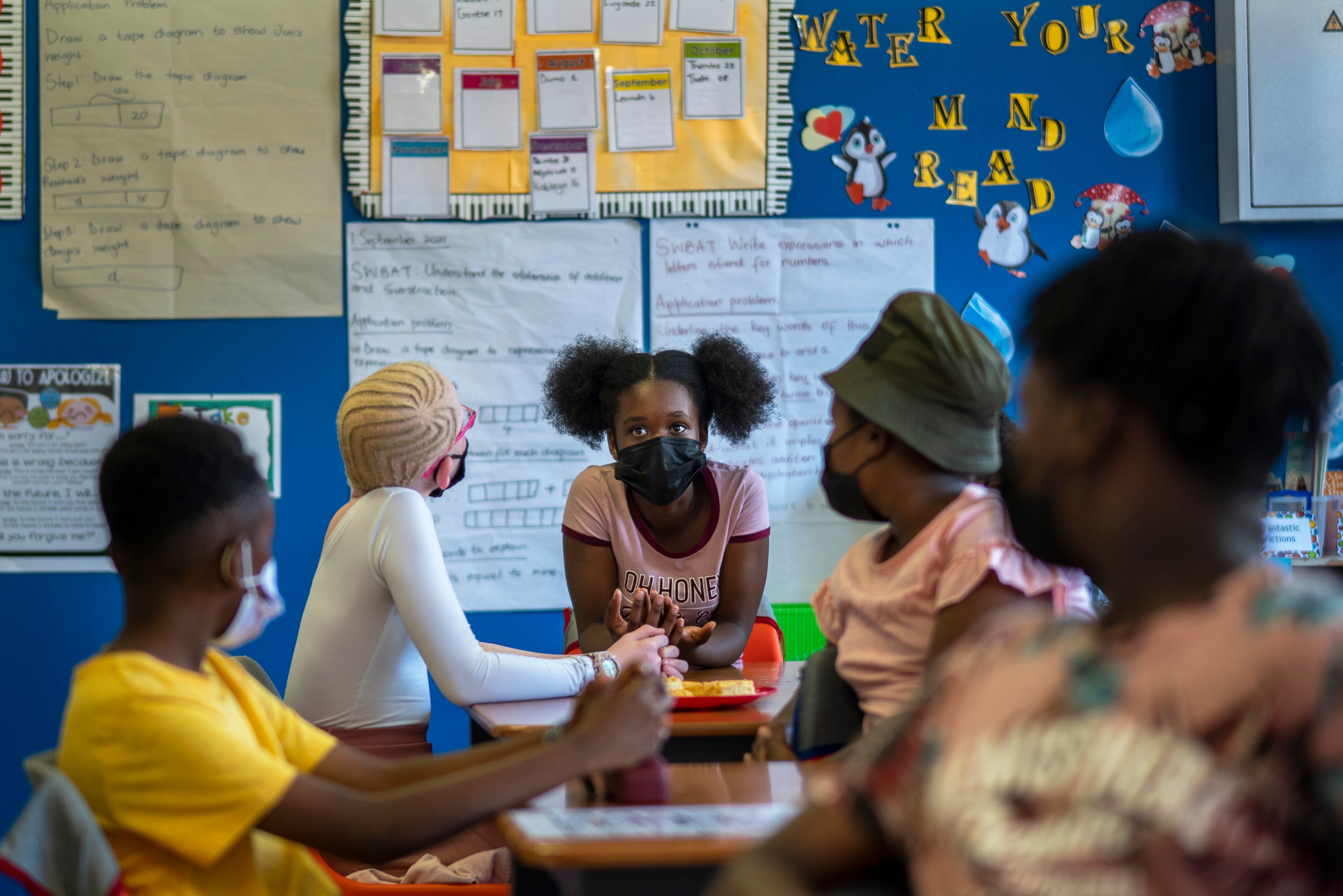 Pupils wearing masks study at the Kgololo Academy in Johannesburg's Alexandra township on Tuesday