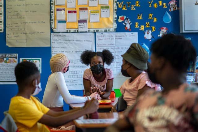 <p>Pupils wearing masks study at the Kgololo Academy in Johannesburg's Alexandra township on Tuesday</p>