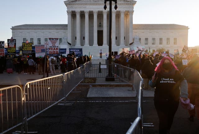 <p>Anti-abortion and pro-abortion rights activists are separated by a barrier as they protest outside the Supreme Court building, ahead of arguments in the Mississippi abortion rights case Dobbs v. Jackson Women's Health, in Washington, U.S., December 1, 2021. </p>