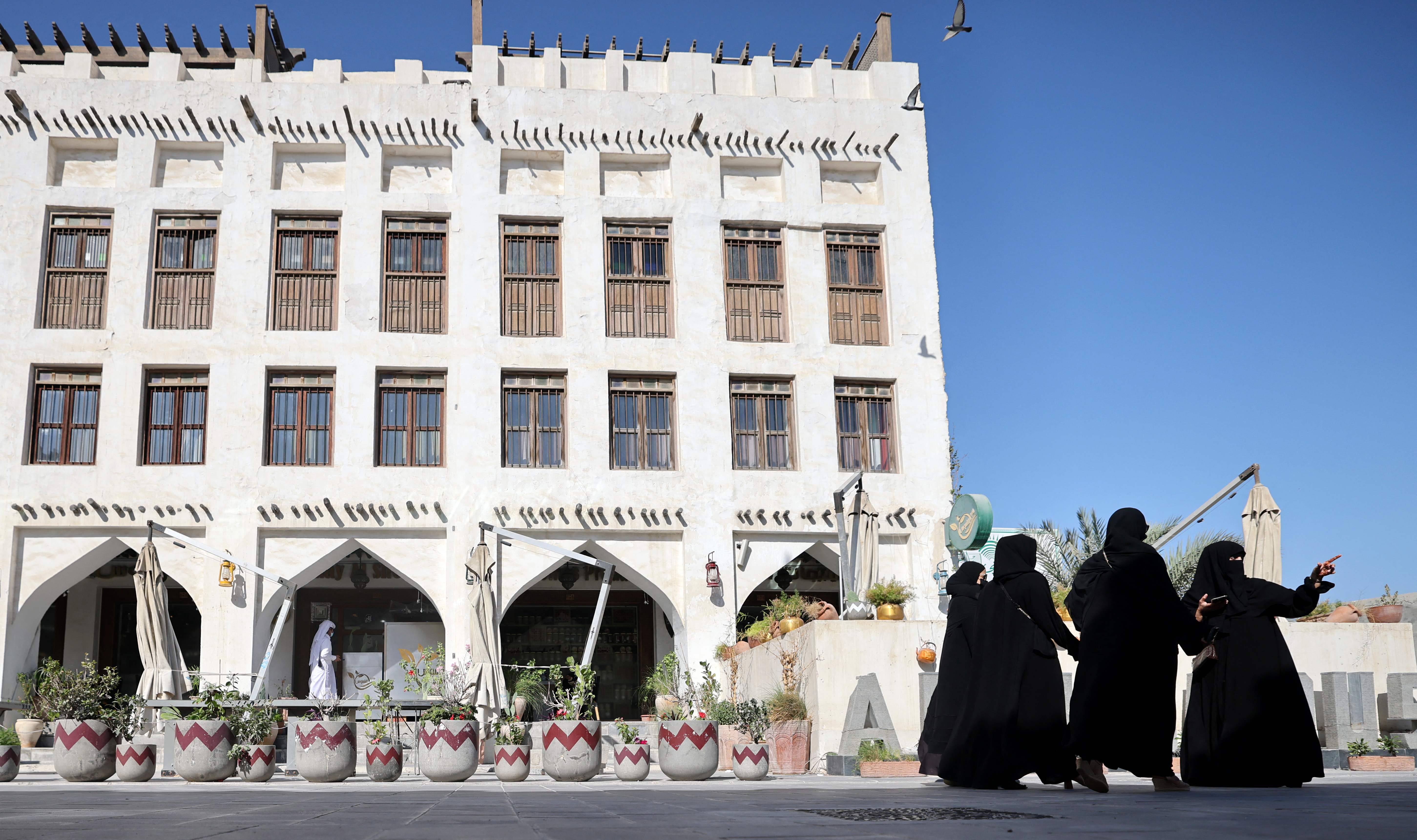 Women are pictured outside a traditional Qatari building in Doha