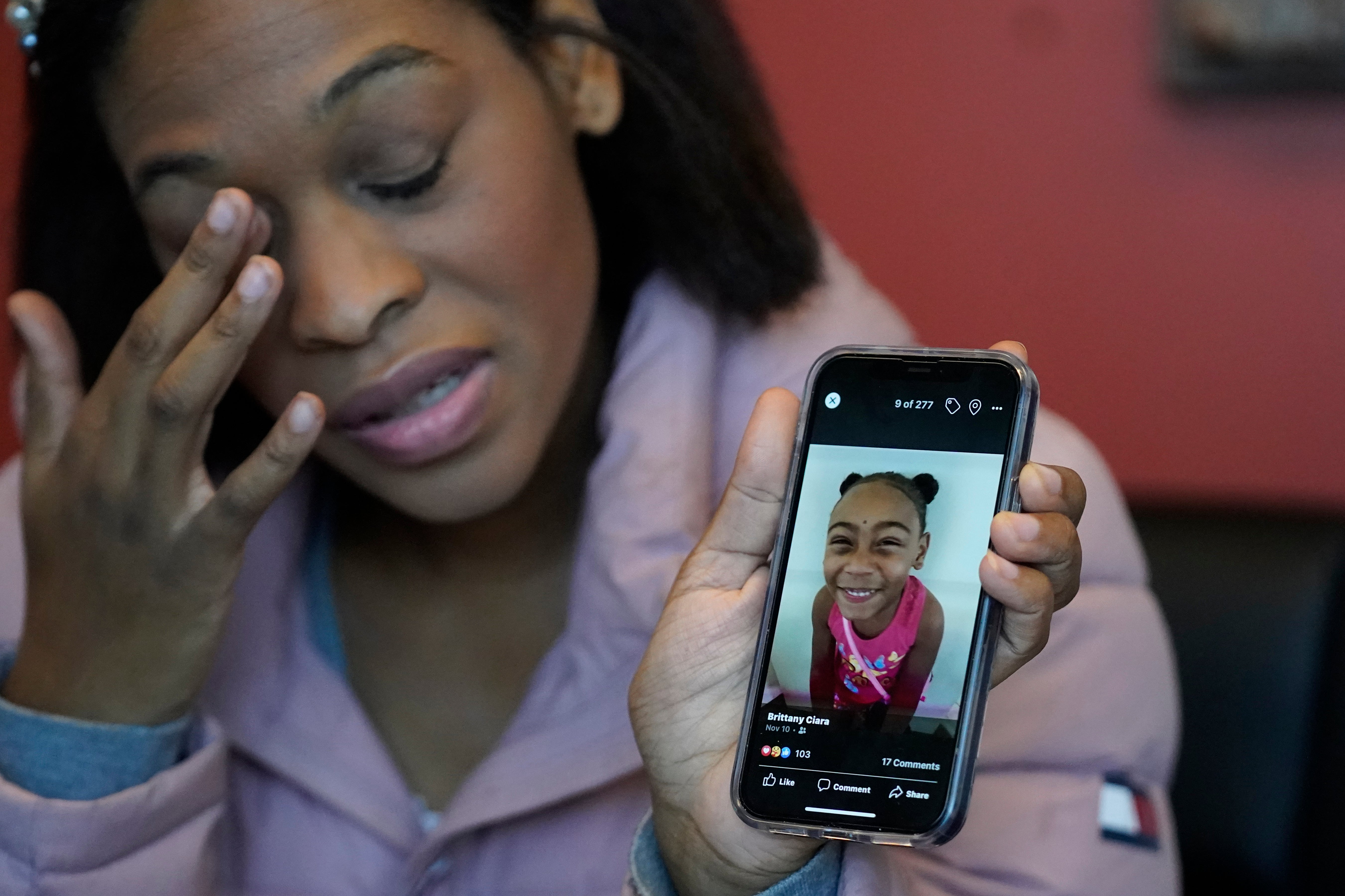 Brittany Tichenor-Cox, holds a photo of her daughter, Isabella "Izzy" Tichenor, during an interview Monday, Nov. 29, 2021, in Draper, Utah. Tichenor-Cox said her 10-year-old daughter died by suicide after she was harassed for being Black and autistic at school. She is speaking out about the school not doing enough to stop the bullying. (AP Photo/Rick Bowmer)