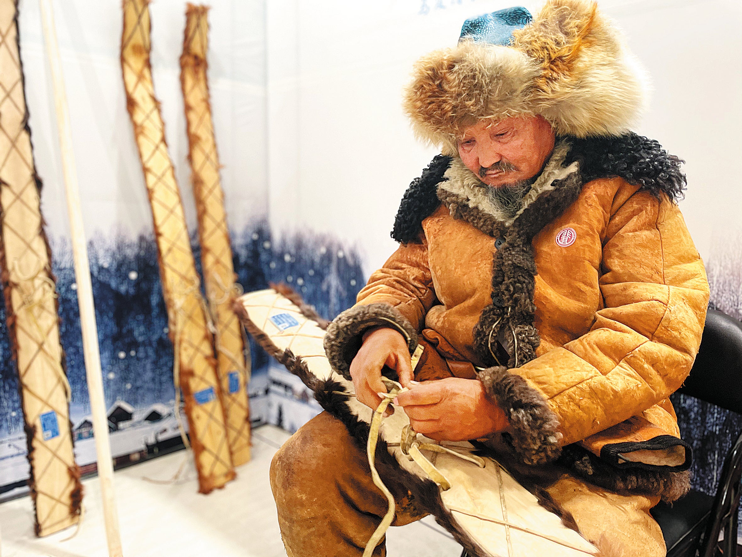 Silambek Sakish showcases fur skis he has made at an intangible cultural heritage exhibition held in Urumqi, Xinjiang, in October