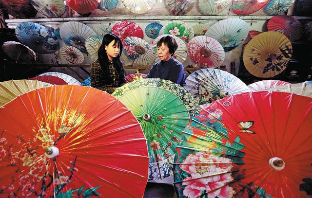 <p>Li Zhenxia (right) and her daughter in her shop in Datong ancient town in Chishui, Guizhou province </p>