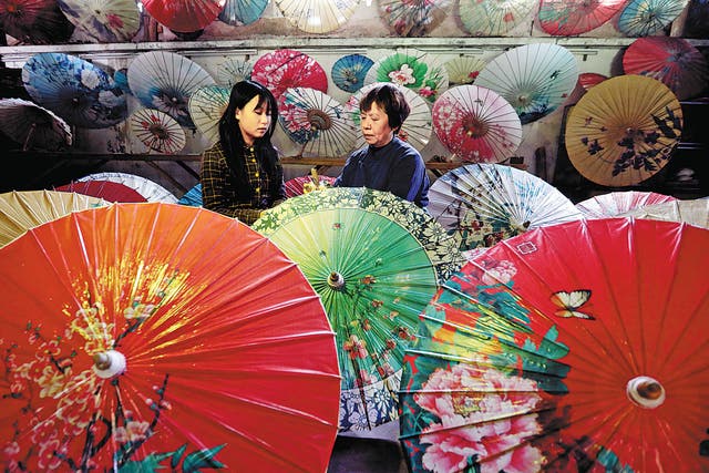 <p>Li Zhenxia (right) and her daughter in her shop in Datong ancient town in Chishui, Guizhou province </p>