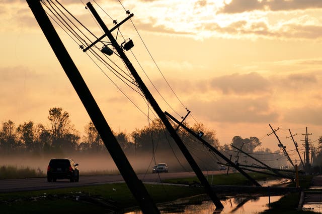 <p>Downed power lines slump over a road in the aftermath of Hurricane Ida on September 3, 2021, in Reserve, Louisiana (AP Photo/Matt Slocum)</p>