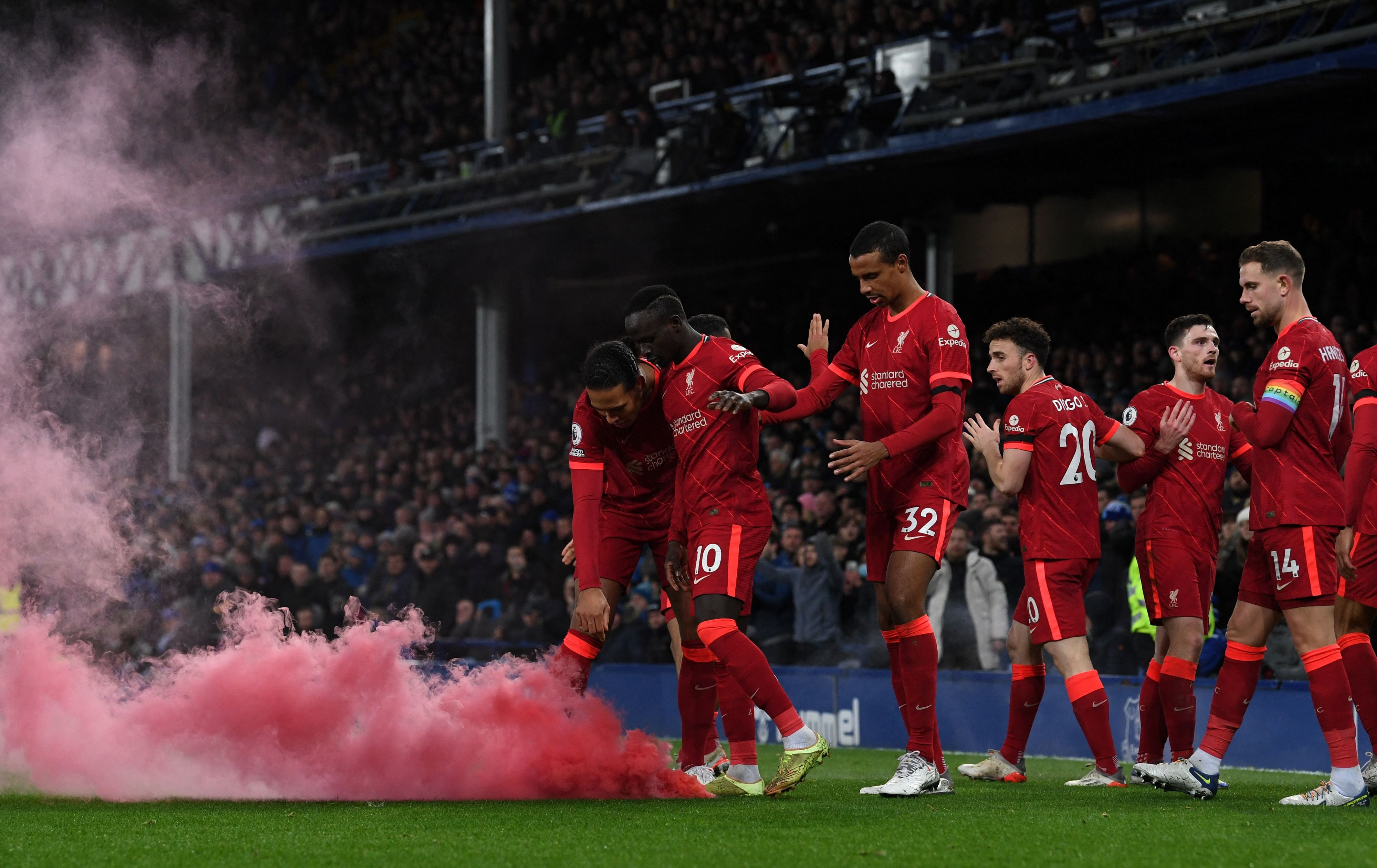 Liverpool players celebrate during their derby win