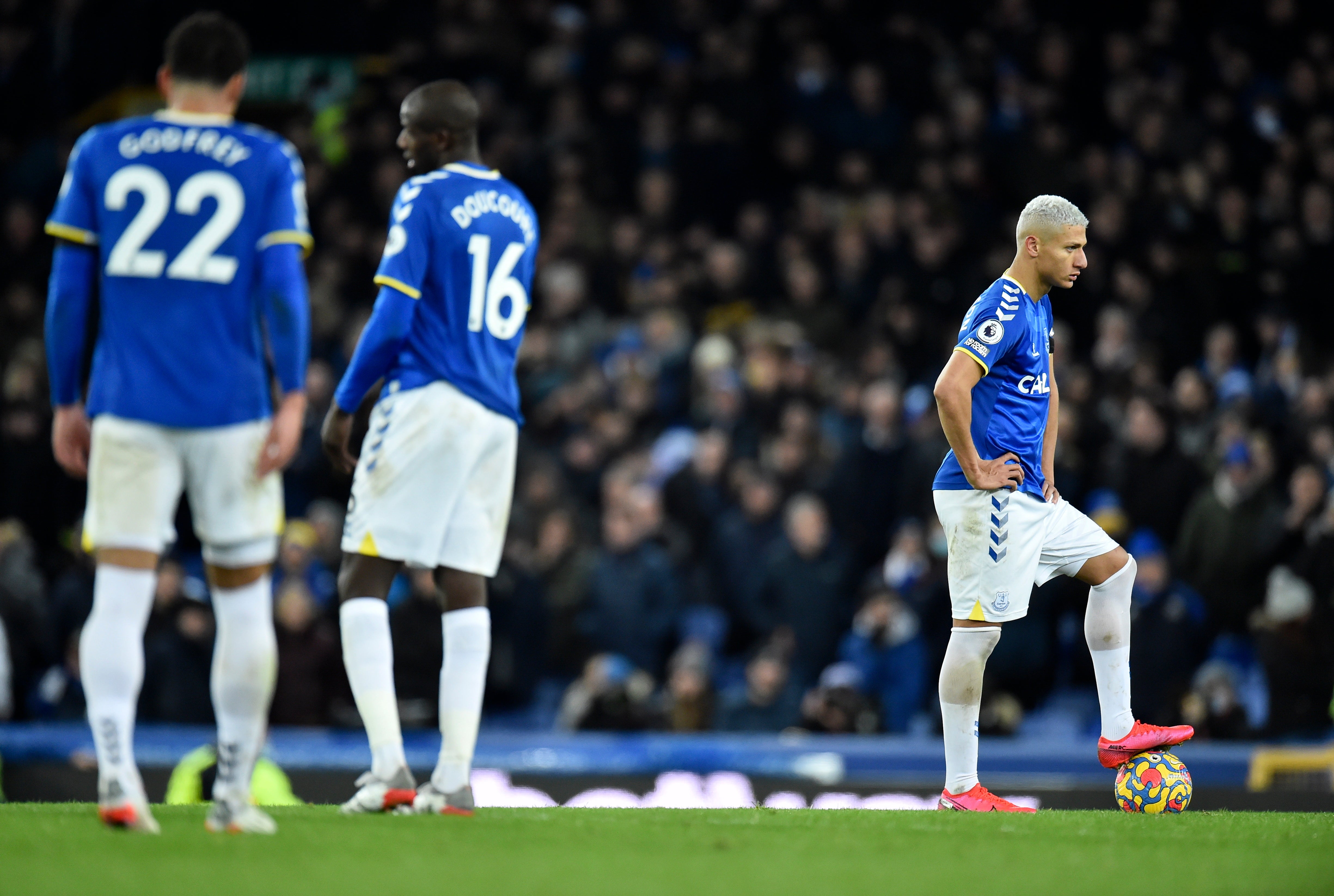 Players of Everton look downbeat after conceding the fourth goal