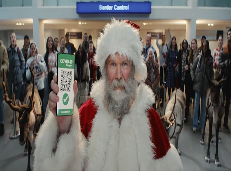 Father Christmas presenting his Covid pass at border control (Tesco/PA)