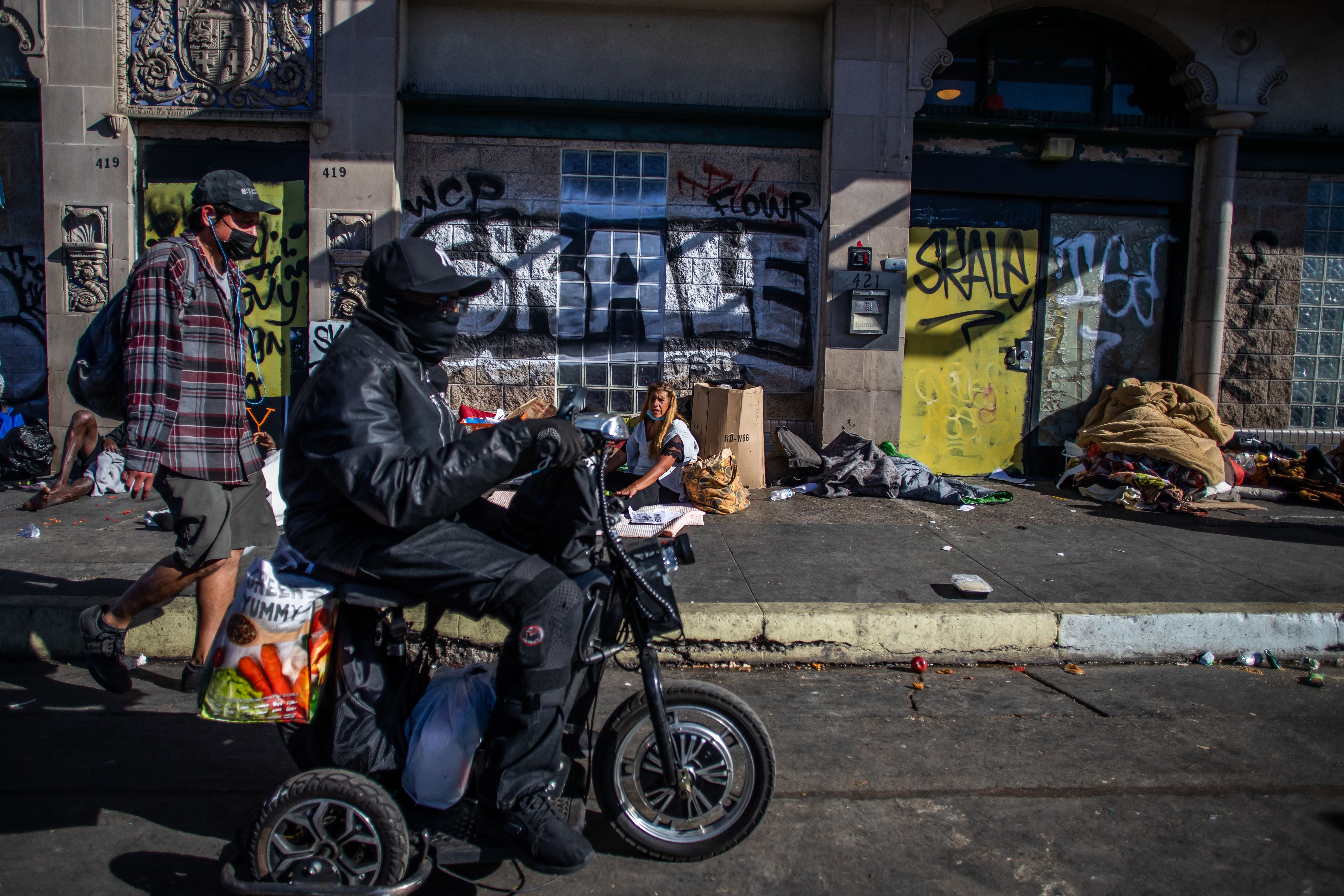 File photo: People walk by the Skid Row neighbourhood of downtown Los Angeles on 25 November