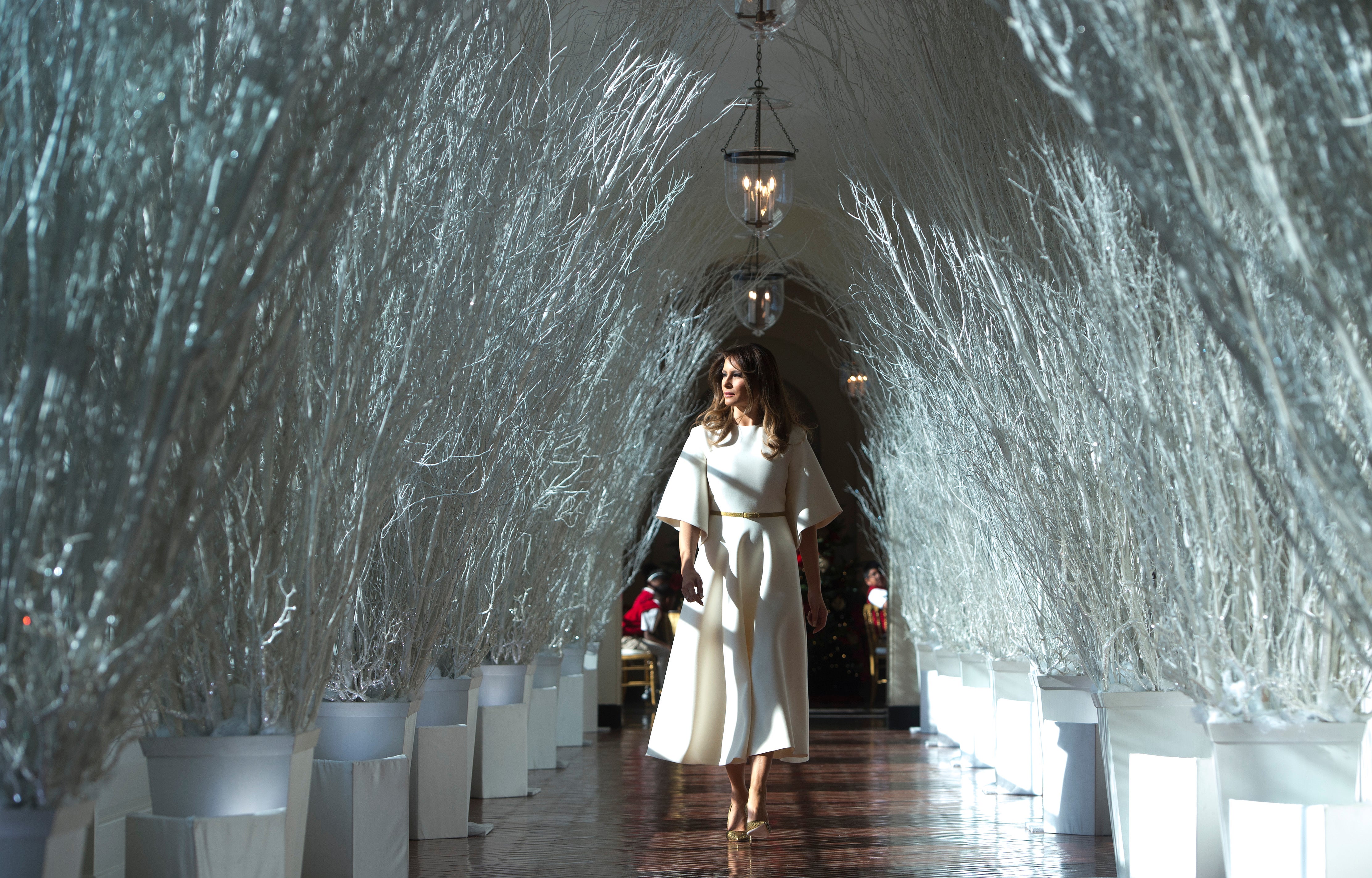 Melania Trump walks through the Christmas decorations in the east wing in 2017