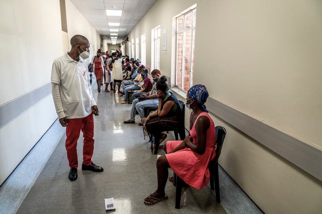 <p>People wait in line to get vaccinated against Covid-19 at the Lenasia South Hospital, near Johannesburg</p>